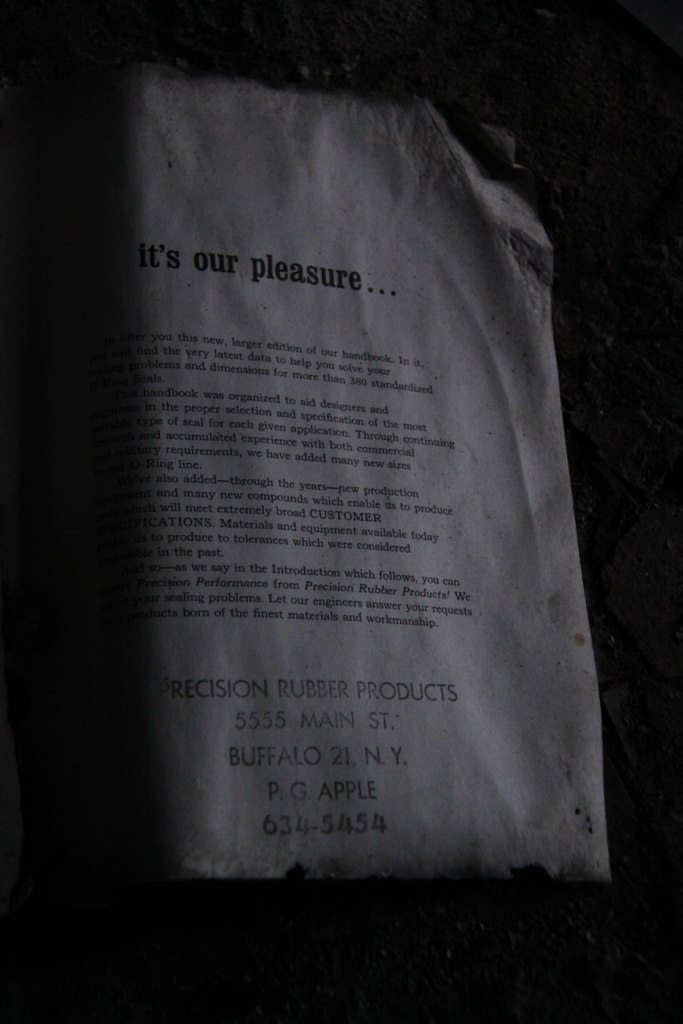 Yellowed handbook page reading "it's our pleasure…" from Precision Rubber Products, 5555 Main St, Buffalo 21, N.Y.