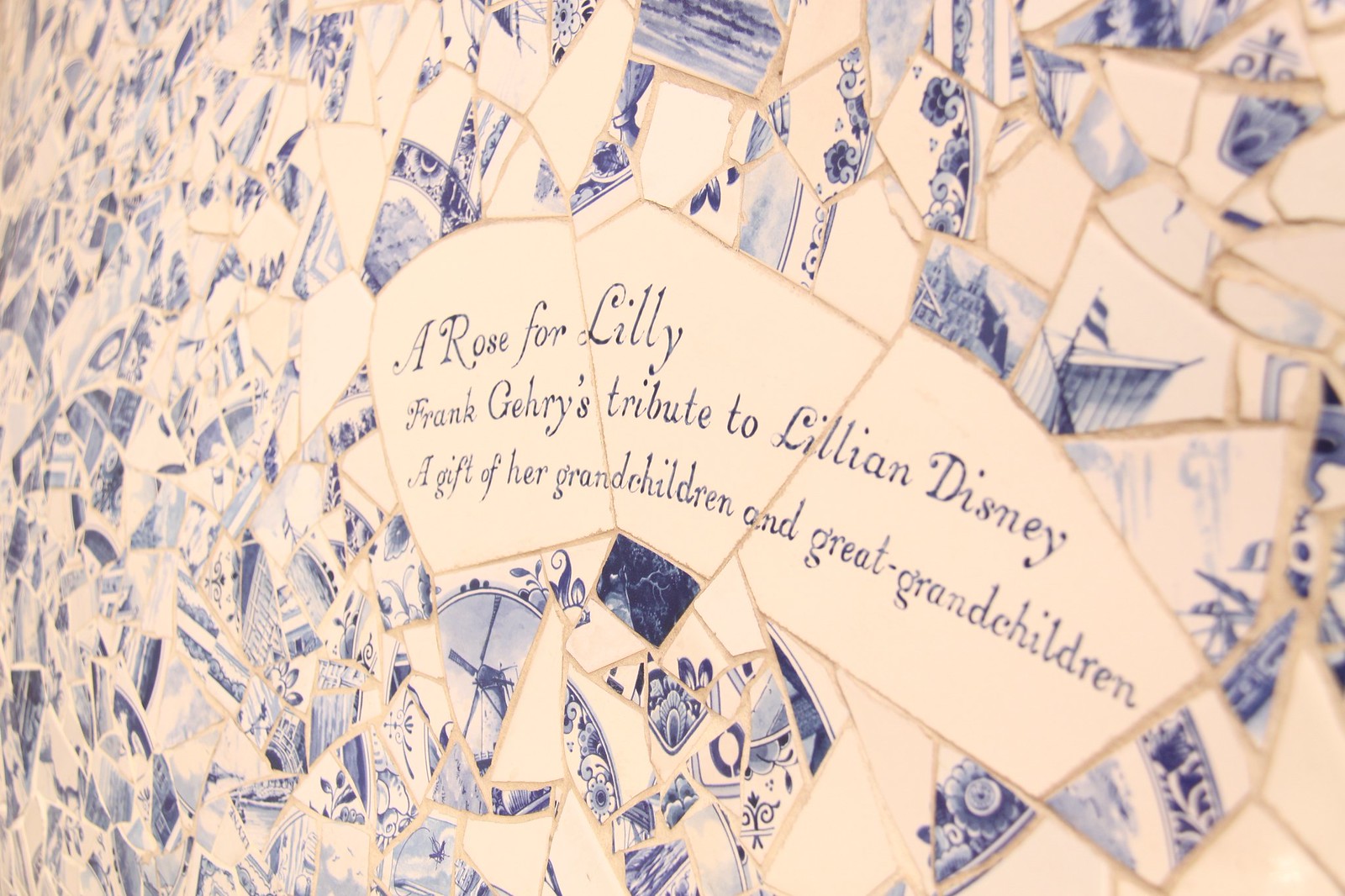 Blue-and-white Delft tile mosaic reading "A Rose for Lilly, Frank Gehry's tribute to Lillian Disney.