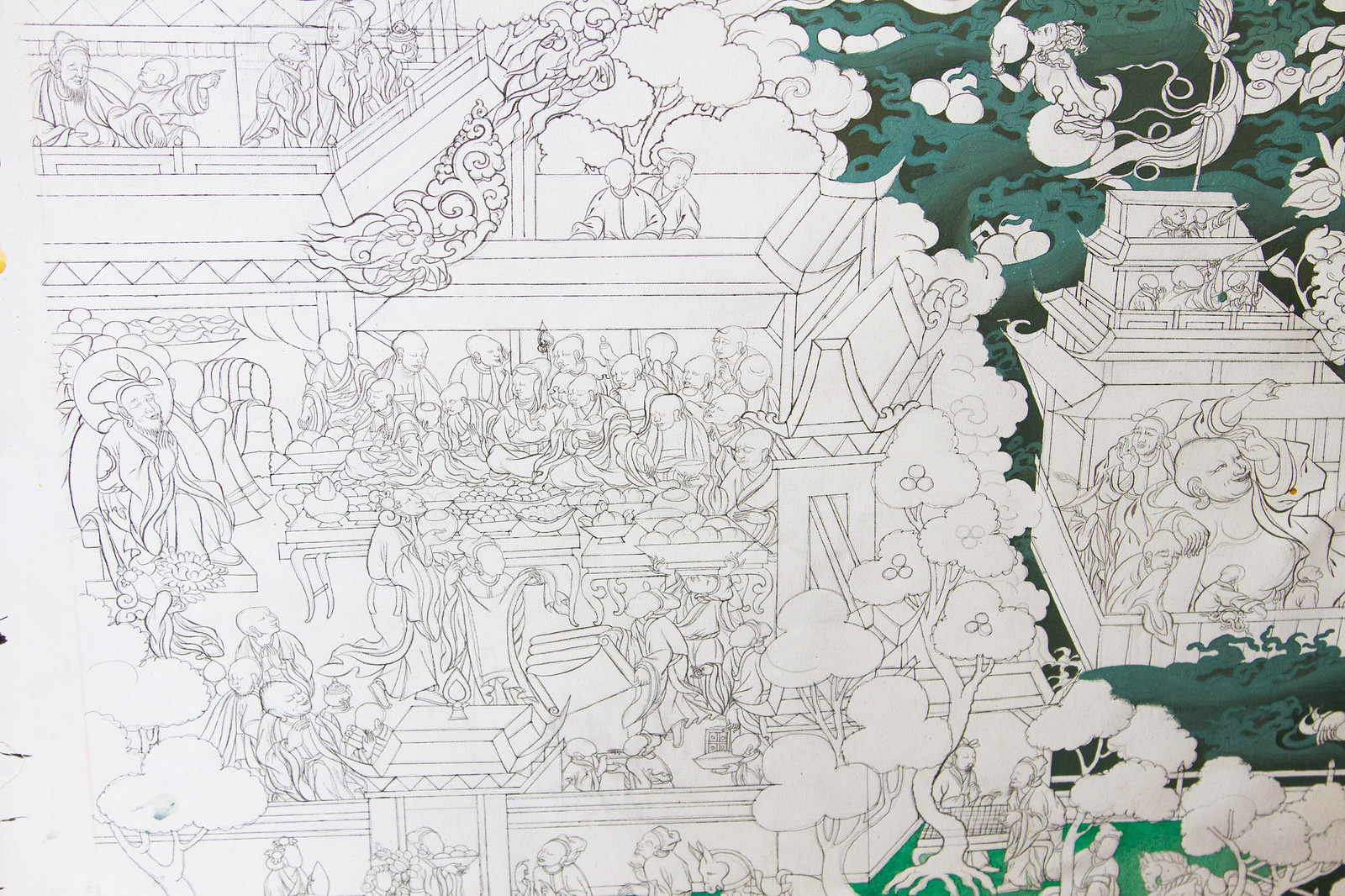 Detailed black-ink Tibetan thangka drawing of monks, temples, and trees with sparse green shading.